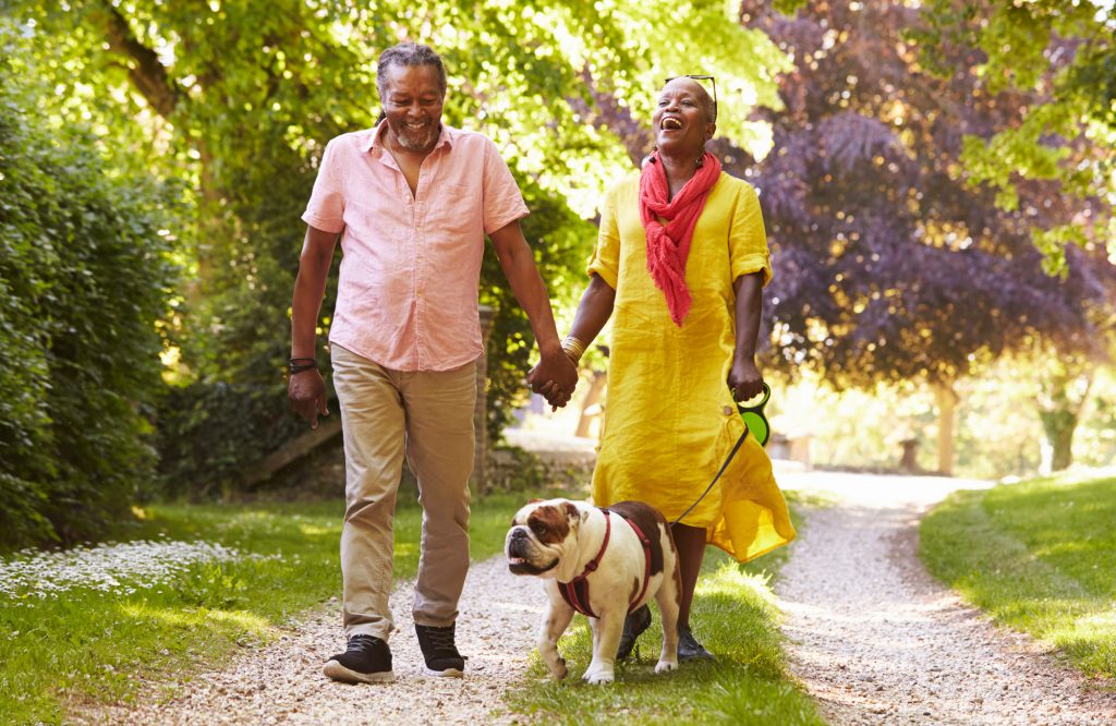 Couple walking dog